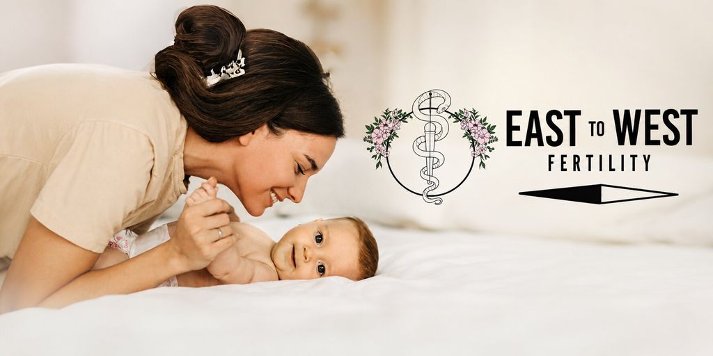 Mother smiling at baby beside East to West Fertility logo, representing personalized fertility care and family-building.