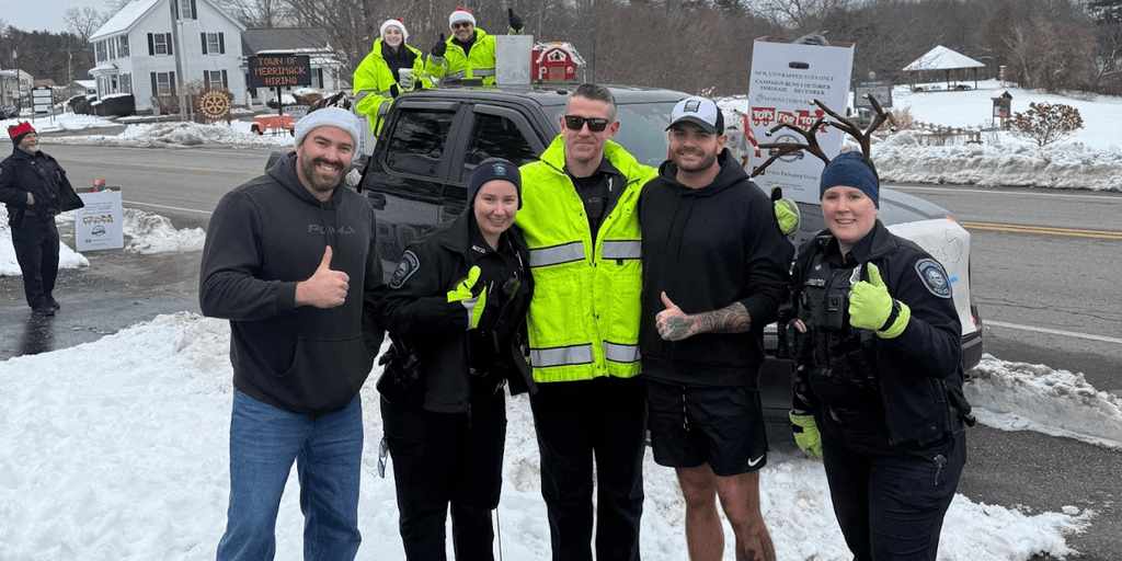 Jason Duffy and local officers participate in a community event supporting the Toys for Tots campaign.