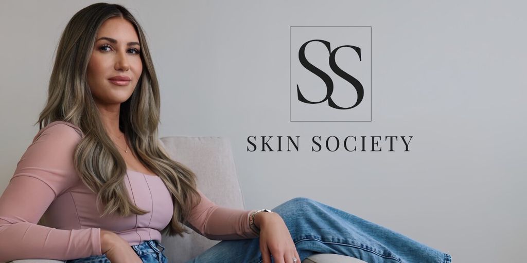 Sally Delory seated beside the Skin Society logo in a promotional brand portrait.