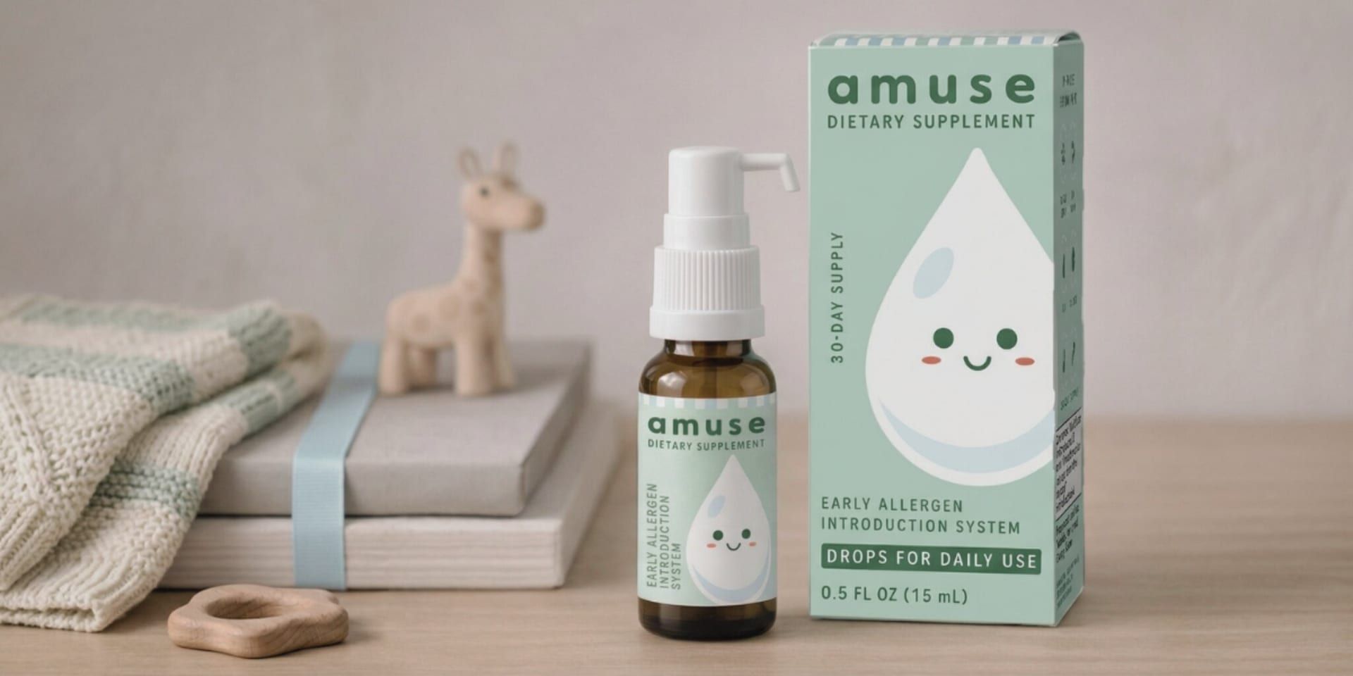 Amuse Drops bottle and packaging displayed beside baby items on a nursery shelf.