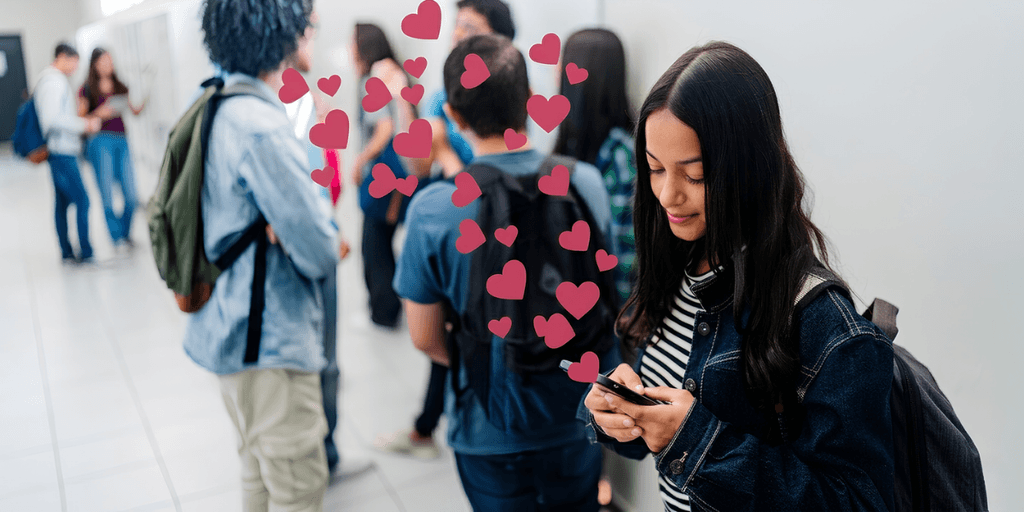 Person using a smartphone while others socialize nearby, illustrating modern online dating.