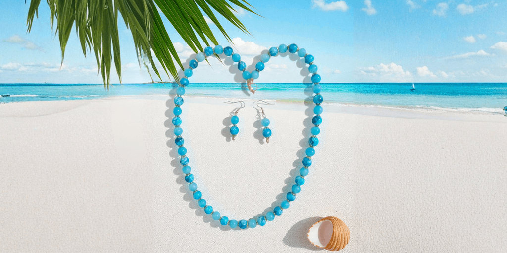 "Handcrafted turquoise jewelry by Crystal’s Beadery, featuring a necklace and earrings on a beach backdrop."