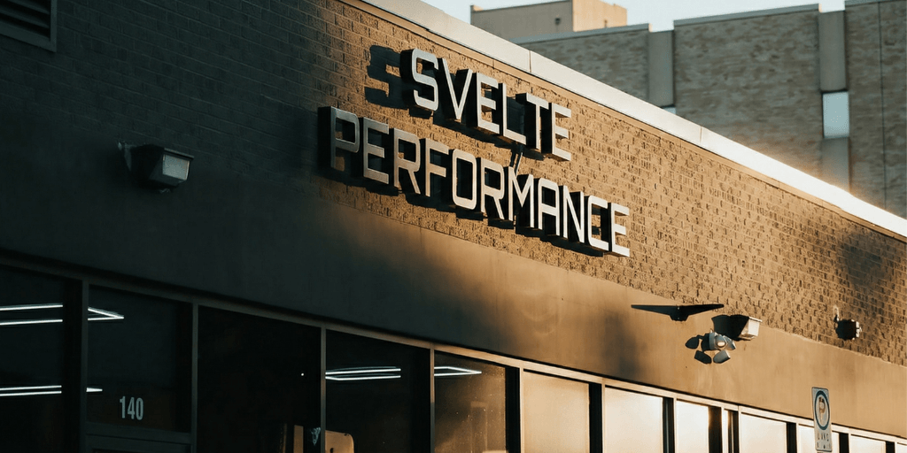 Modern fitness facility showcasing personal training, 24/7 access, and small group workouts, emphasizing performance, flexibility, community, and results-driven wellness experience.