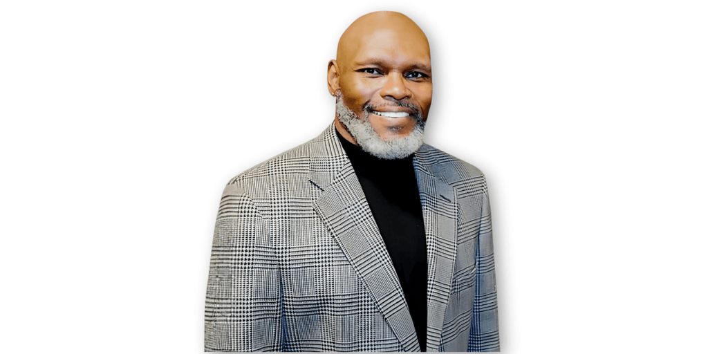 Dr. Michael Anthony Ingram, poet and educator, standing confidently in a professional suit, representing his work with the Poetic Empathy Cards