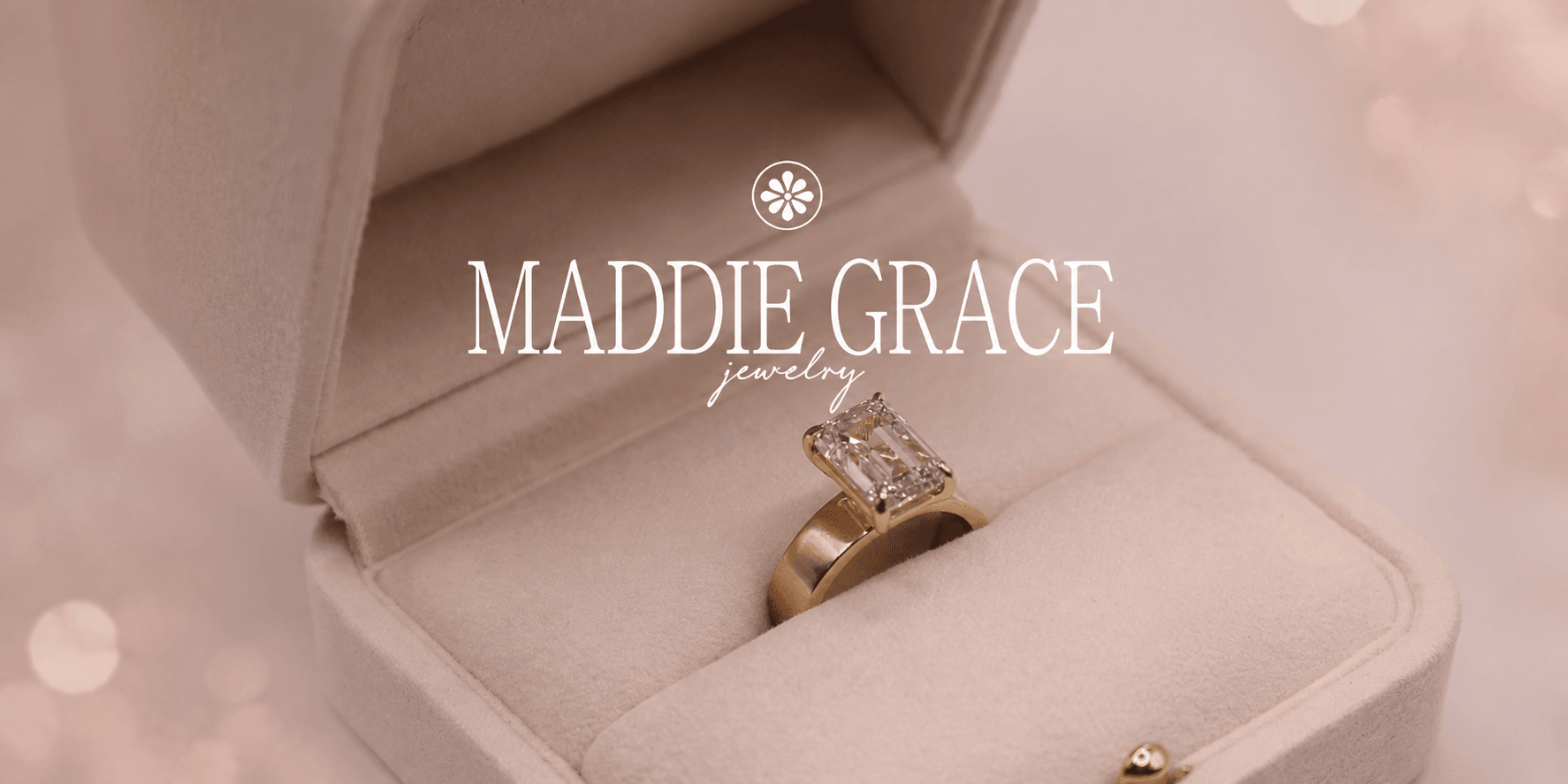 A golden engagement ring with a rectangular diamond in a velvet box
