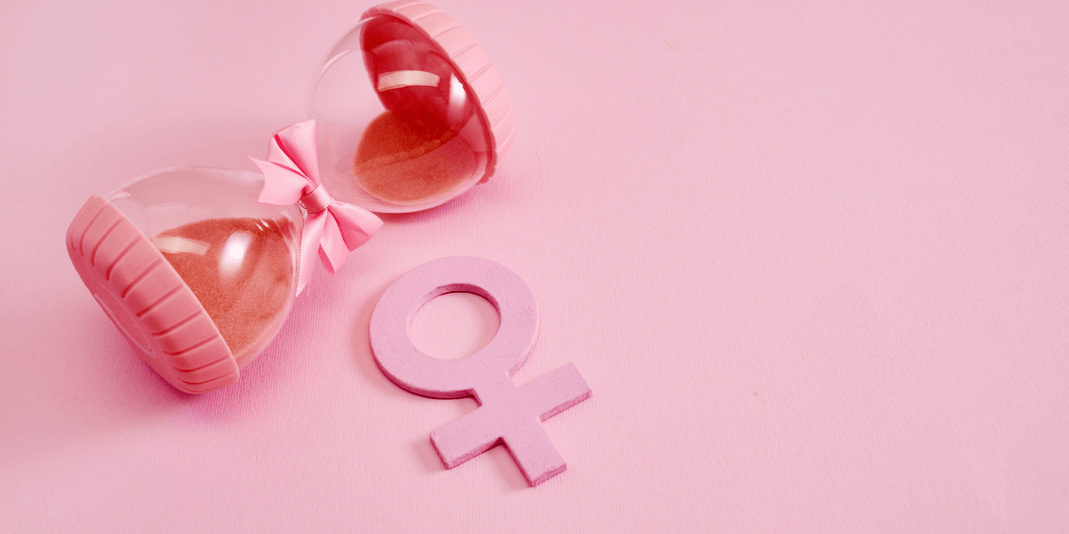 Pink hourglass with a bow next to a pink female gender symbol
