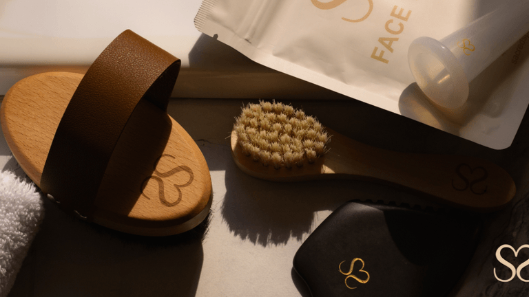 "Sacred Space Self Care products including body and facial brushes, lymphatic tools, and face tape, promoting wellness rituals for women."