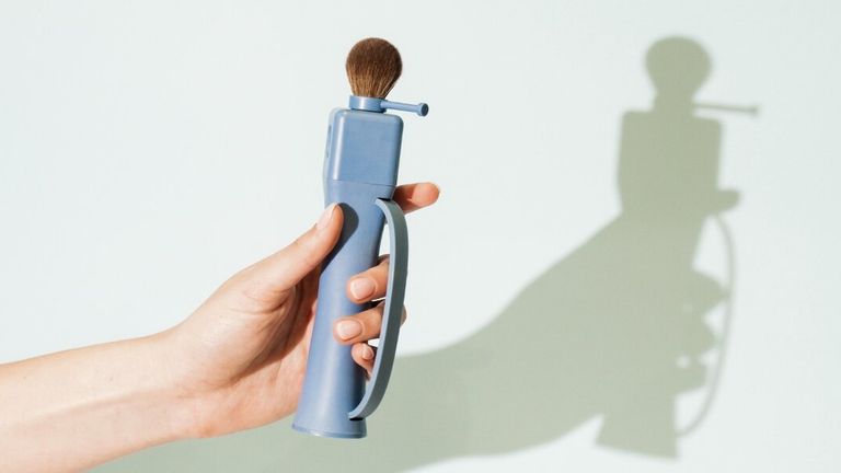 Hand holding Flexxi Beauty’s 4-in-1 interchangeable makeup brush, highlighting ergonomic design and brush head.