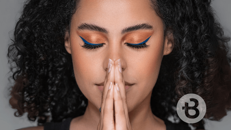 Confident woman with curly hair and bold makeup, showcasing a powerful beauty transformation, emphasizing empowerment and career independence.