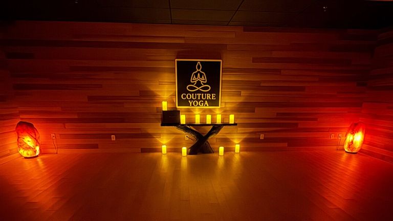 Meditation room at Couture Yoga Institute illuminated by candles and Himalayan salt lamps.