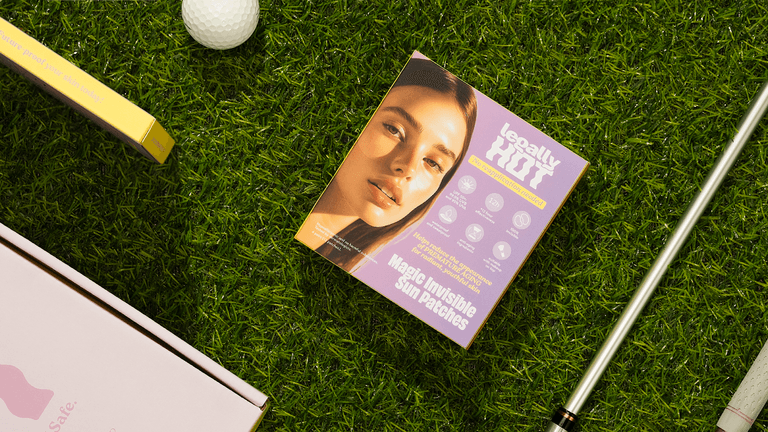 Legally Hot sun protection patch on grass, surrounded by golf equipment, offering 12-hour waterproof, sweatproof UPF50+ protection.