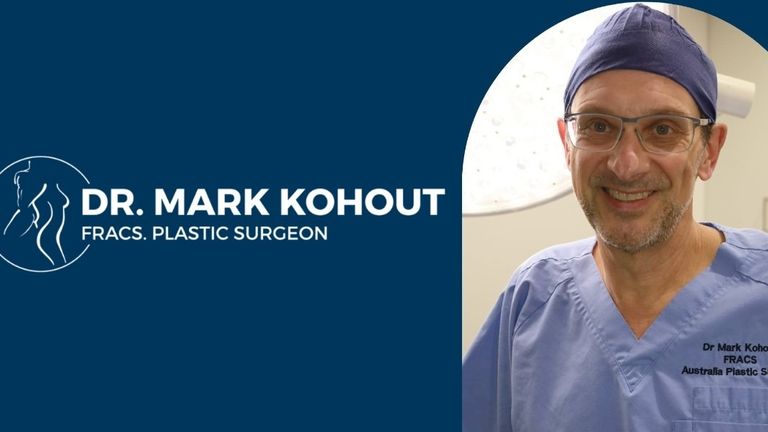 Dr. Mark Kohout in surgical scrubs beside Australia Plastic Surgery branding.