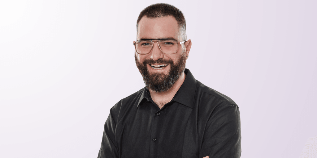 Izac Ross, founder of Haven Headache & Migraine Center, smiling confidently in a professional photo.