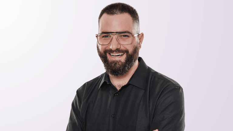 Izac Ross, founder of Haven Headache & Migraine Center, smiling confidently in a professional photo.