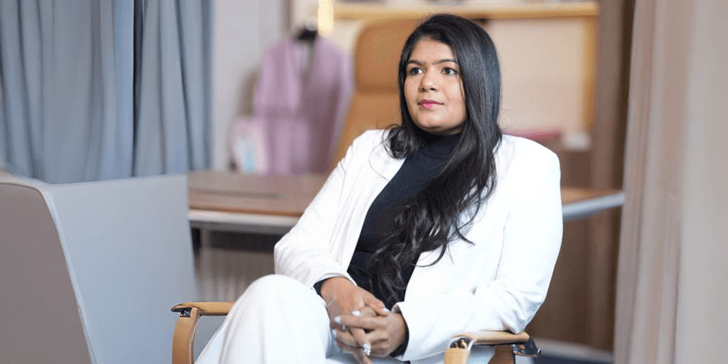 Portrait of Ashwini Kotaru in white blazer, reflecting leadership, innovation, and purpose-driven entrepreneurship.