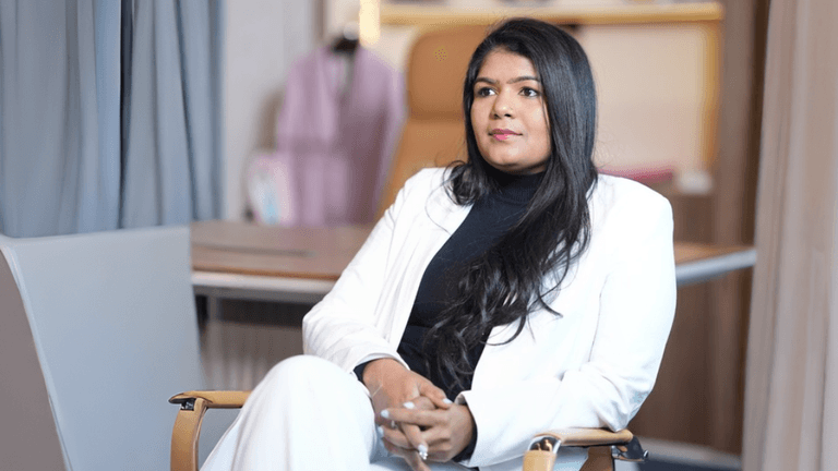 Portrait of Ashwini Kotaru in white blazer, reflecting leadership, innovation, and purpose-driven entrepreneurship.