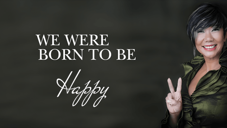 Smiling woman in green outfit flashing peace sign with text: "We Were Born to Be Happy."
