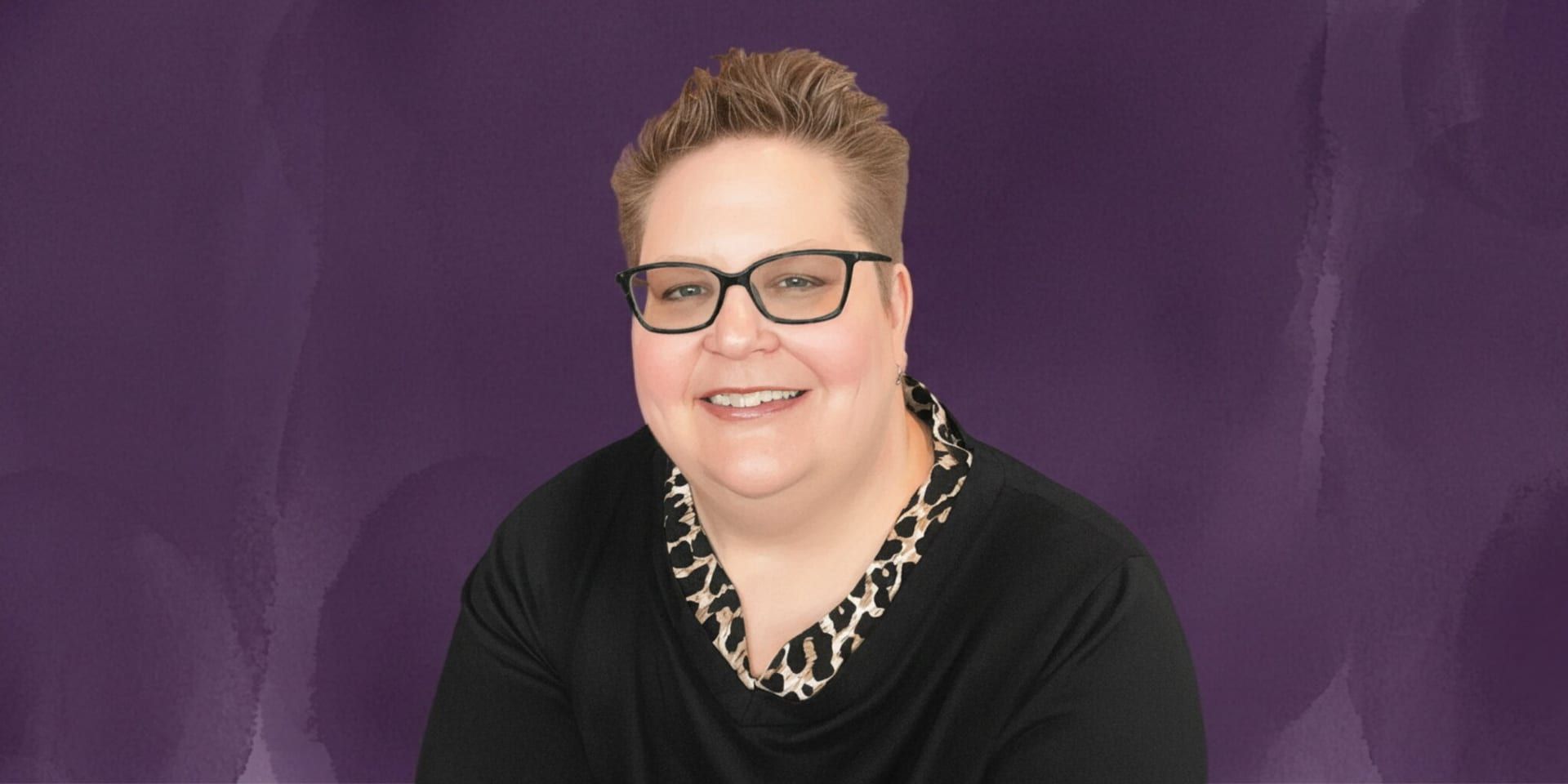Portrait of self-care mentor Mickey Forsyth smiling against a purple background.