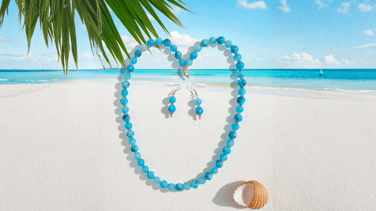 "Handcrafted turquoise jewelry by Crystal’s Beadery, featuring a necklace and earrings on a beach backdrop."