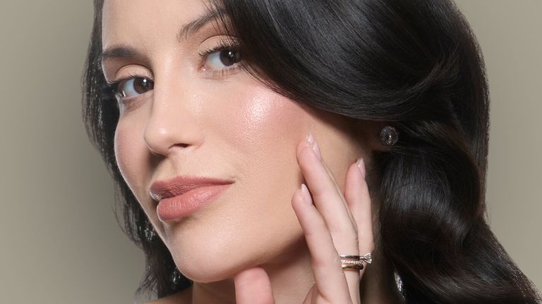 A close-up portrait of Dr. Tainah Almeida, showcasing her natural beauty, emphasizing subtle elegance and skin vitality.
