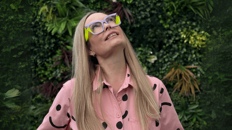 Emmaline McAndrew smiling in pink shirt, representing The Slow Businesswoman, a business platform for women with chronic illness.