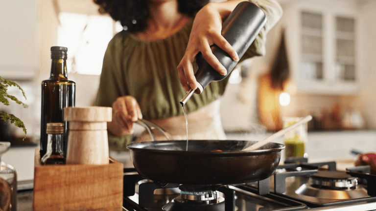 a woman cooking, reflecting Simply Stocked’s mission to simplify mealtime for busy families with ease.