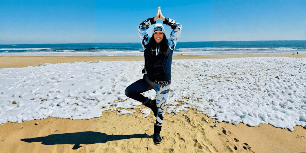 "Kimberly Vega, Army veteran and founder of Zenith Soul, demonstrates yoga on the beach, promoting mind-body-spirit healing and empowerment."