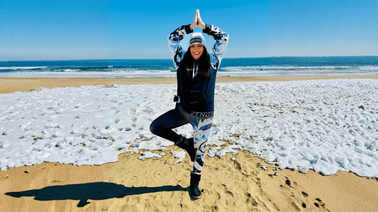 "Kimberly Vega, Army veteran and founder of Zenith Soul, demonstrates yoga on the beach, promoting mind-body-spirit healing and empowerment."