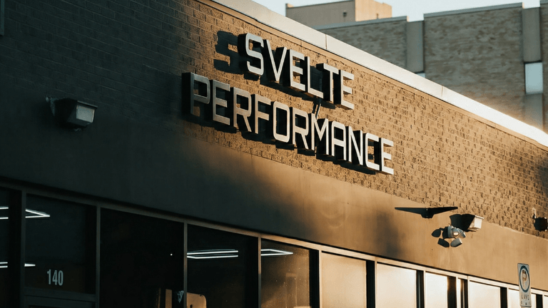 Modern fitness facility showcasing personal training, 24/7 access, and small group workouts, emphasizing performance, flexibility, community, and results-driven wellness experience.