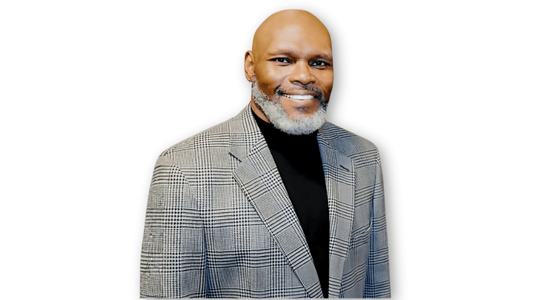 Dr. Michael Anthony Ingram, poet and educator, standing confidently in a professional suit, representing his work with the Poetic Empathy Cards