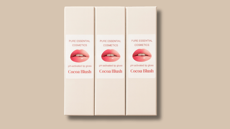 "Pure Essential Cosmetics Cocoa Blush pH-reactive lip gloss, offering personalized color transformation and luxurious hydration with a chocolate scent."