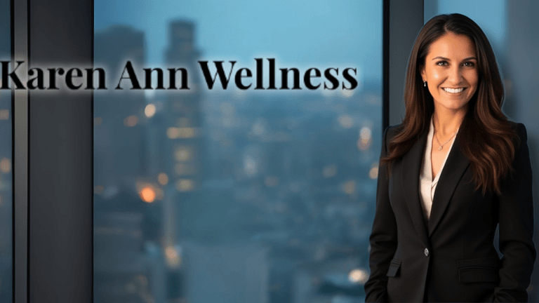 "Woman in a black suit with long brunette hair standing in front of a city skyline, with the text 'Karen Ann Wellness' overlaying the image."