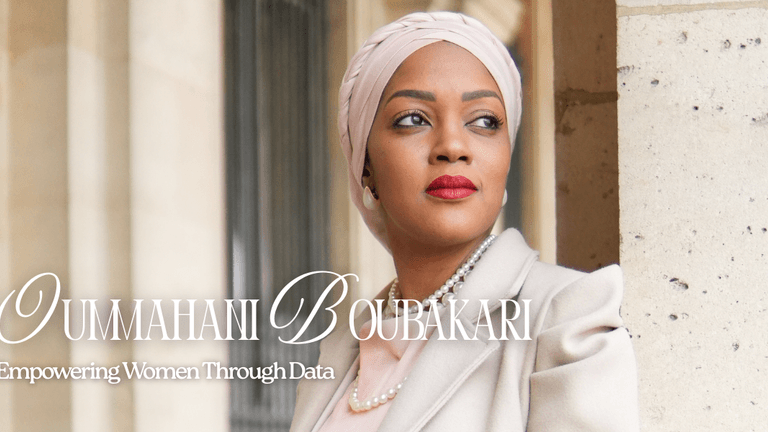 "Professional portrait of Oumahani Boubakari, an inspiring woman empowering women through data, wearing a headscarf and a beige coat, with a soft focus background."