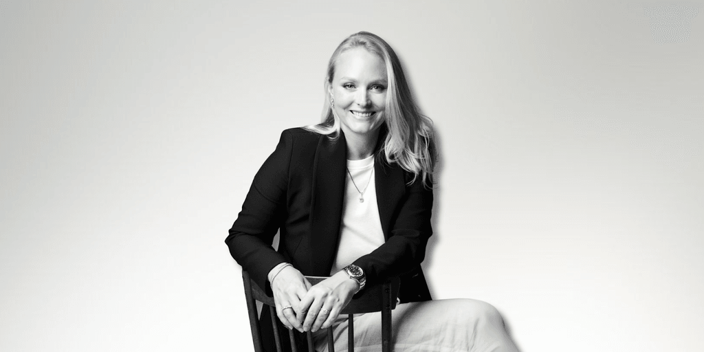 Milena Dold, founder of IRALIS, confidently seated and smiling, embodies the empowerment and luxury of self-purchased diamonds, symbolizing independence, achievement, and a redefined approach to personal milestones in the jewelry industry.