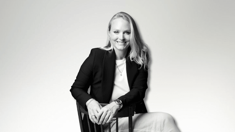 Milena Dold, founder of IRALIS, confidently seated and smiling, embodies the empowerment and luxury of self-purchased diamonds, symbolizing independence, achievement, and a redefined approach to personal milestones in the jewelry industry.