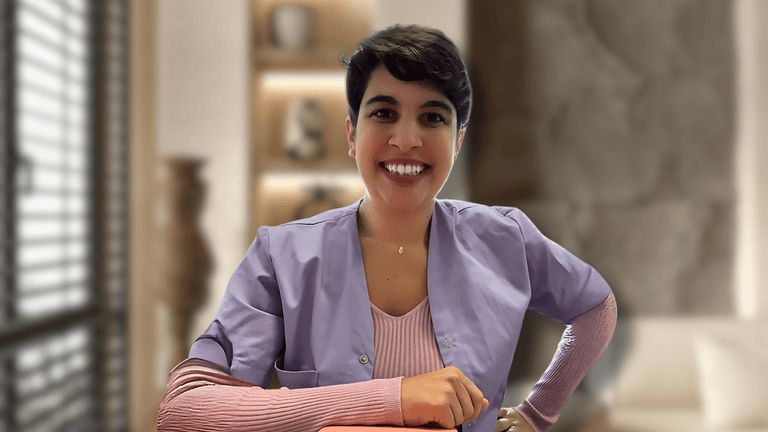 Amalia Pavlidi, founder of Alternative Therapies B.V., smiling in her professional attire, representing the holistic wellness and natural skincare services of her company in the Netherlands.