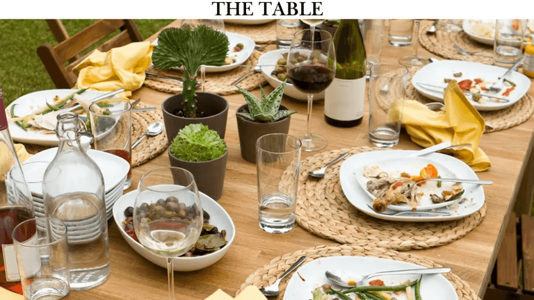 An inviting dining table with plants, glassware, and plates, symbolizing connection and community, perfect for Sandra's faith-driven program.
