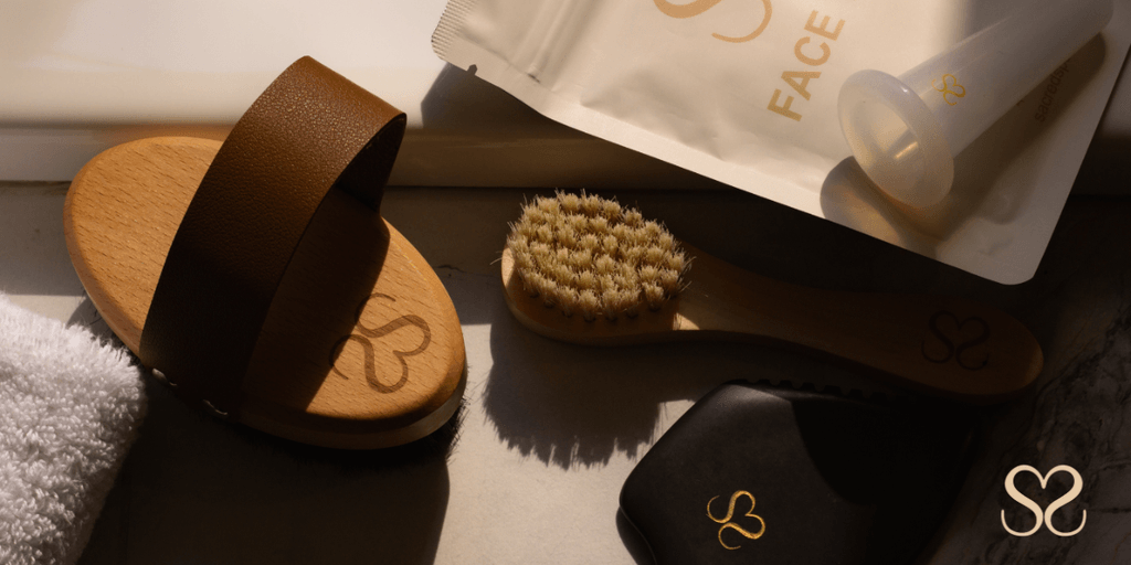 "Sacred Space Self Care products including body and facial brushes, lymphatic tools, and face tape, promoting wellness rituals for women."
