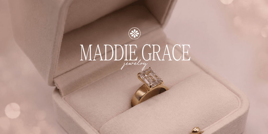 A golden engagement ring with a rectangular diamond in a velvet box