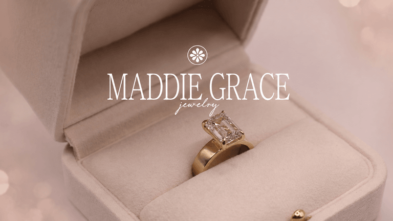 A golden engagement ring with a rectangular diamond in a velvet box