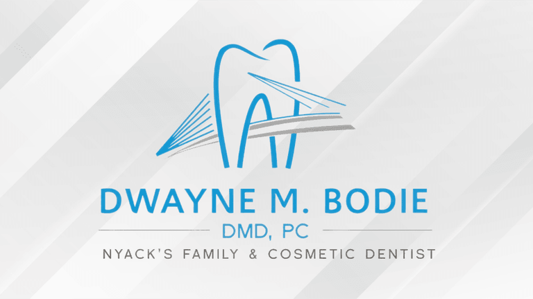 Logo for Dwayne M. Bodie, DMD, PC, featuring a dental motif and text.