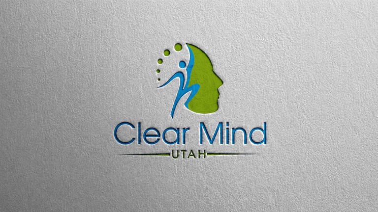 Logo for Clear Mind Utah featuring a profile silhouette and abstract figures in green and blue