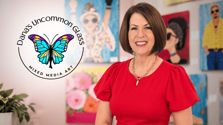 A woman stands in front of colorful artwork with a logo for Dana's Uncommon Glass