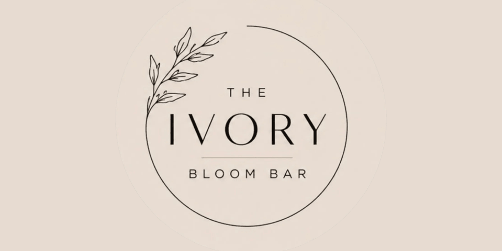Logo for The Ivory Bloom Bar featuring elegant typography and leafy accent design