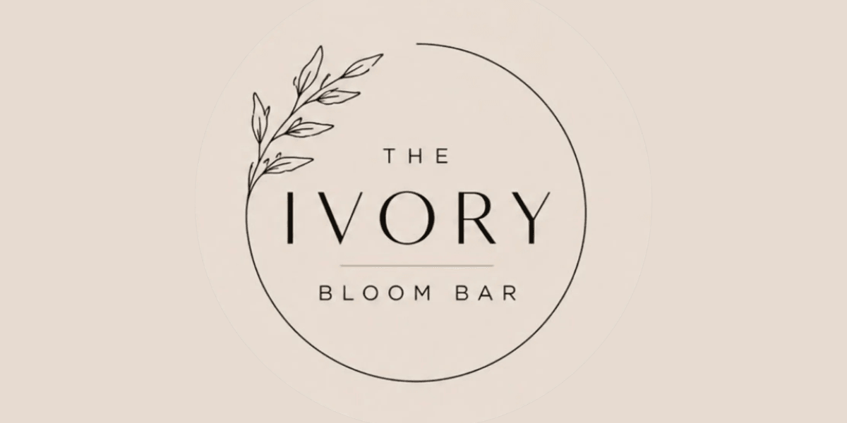 Logo for The Ivory Bloom Bar featuring elegant typography and leafy accent design
