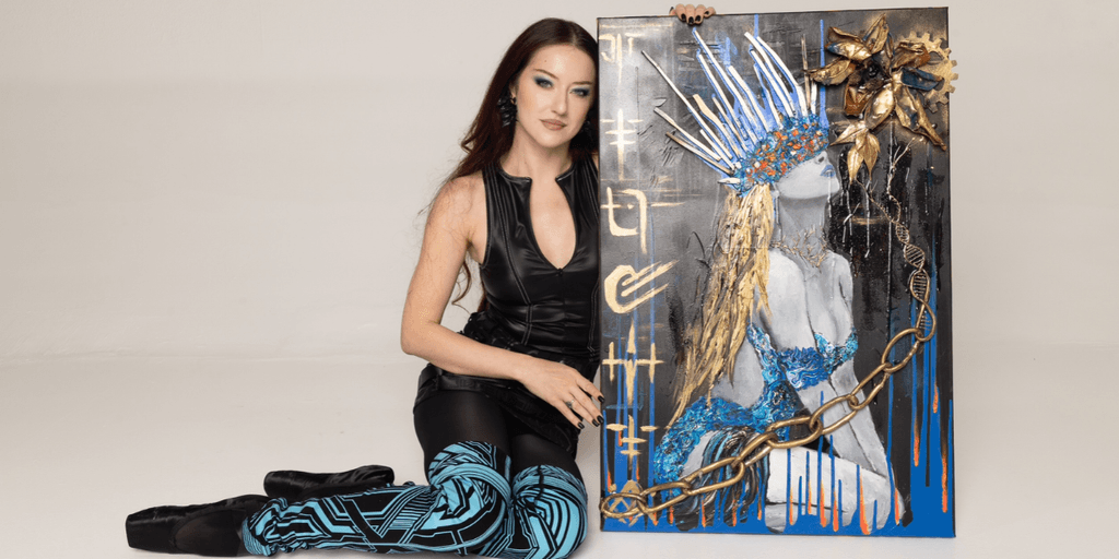 A woman in a black outfit poses beside a vibrant painted artwork on canvas