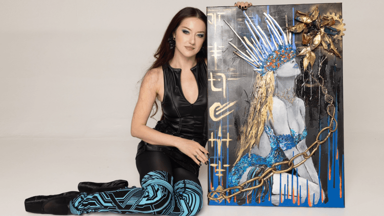 A woman in a black outfit poses beside a vibrant painted artwork on canvas