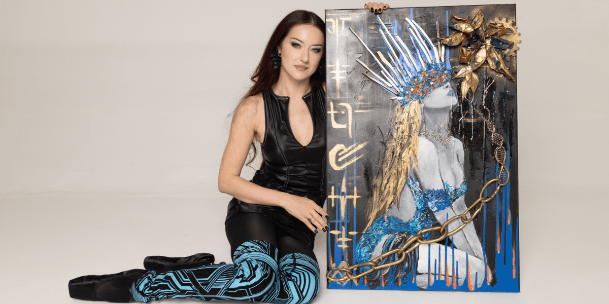 A woman in a black outfit poses beside a vibrant painted artwork on canvas