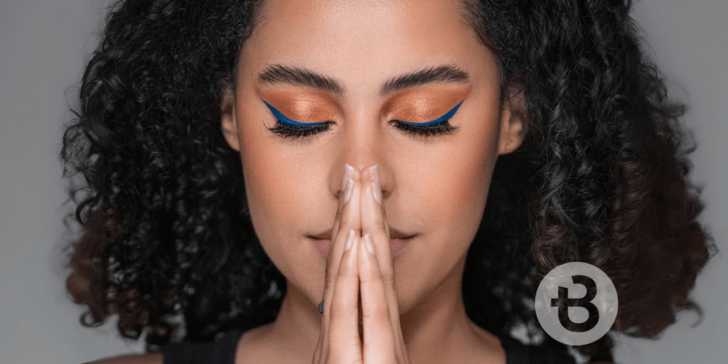 Confident woman with curly hair and bold makeup, showcasing a powerful beauty transformation, emphasizing empowerment and career independence.