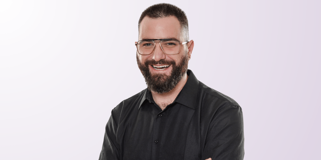 Izac Ross, founder of Haven Headache & Migraine Center, smiling confidently in a professional photo.